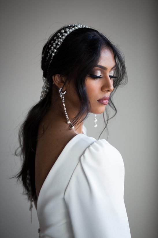 Silver, crystals and pearls come together in a symphony of bridal beauty with these chic earrings. A delicate moon shape and a cascade of pearls and stars fall softy and frame the face perfectly. A lot of detail and craftsmanship have gone into the creation of these beautiful earrings.