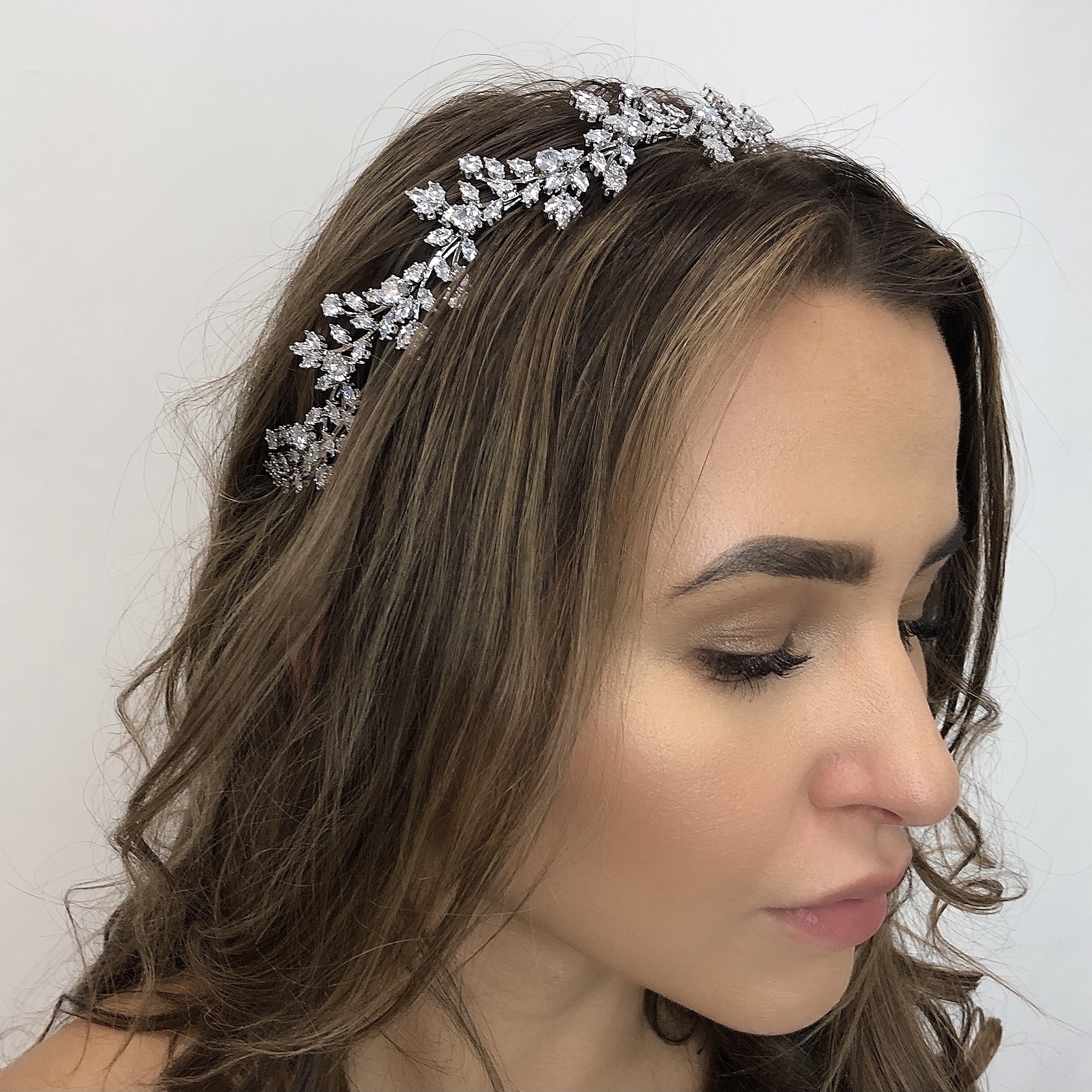 We love the affect created with various shaped crystals that are meticulously assembled with the finest grade cubic zirconia. Individually hand set, just like diamonds, their brilliance will shine bright, catching the light as you enjoy your wedding day. The intricate details of this bridal headpiece will be appreciated by the discerning bride and is a stunning addition to your wedding look evoking a confidence that lets you shine inside and out.